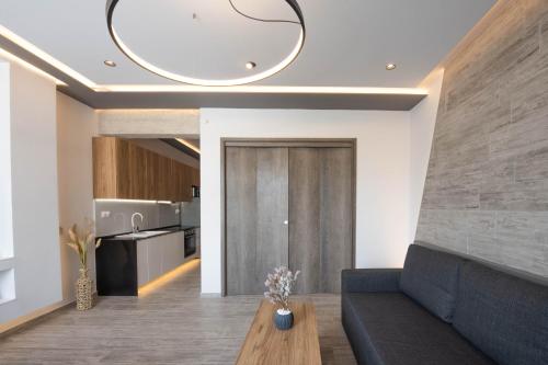 a living room with a couch and a table at SKIA luxury living above the walls in Thessaloniki