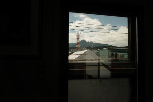 a window with a view of a mountain at Barber HARUNA in Akutsu
