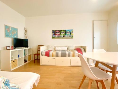 a bedroom with a bed and a table at Casa do Pátio in Figueira da Foz