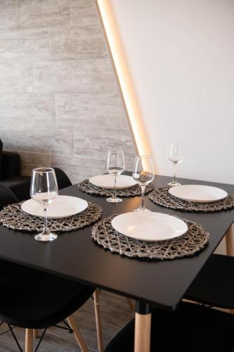 a black table with wine glasses on it at SKIA luxury living above the walls in Thessaloniki