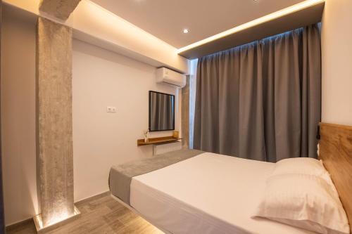 a bedroom with a bed and a window at SKIA luxury living above the walls in Thessaloniki