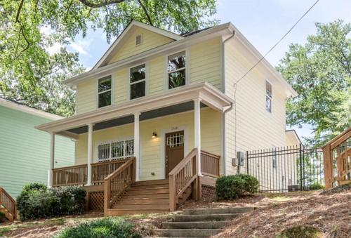a yellow house with a porch and stairs at Cozy Cottage - Walk to Campus, Stadium, Downtown in Athens