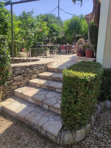a set of stone steps leading to a patio at Villa Mitsi Sarande in Sarandë