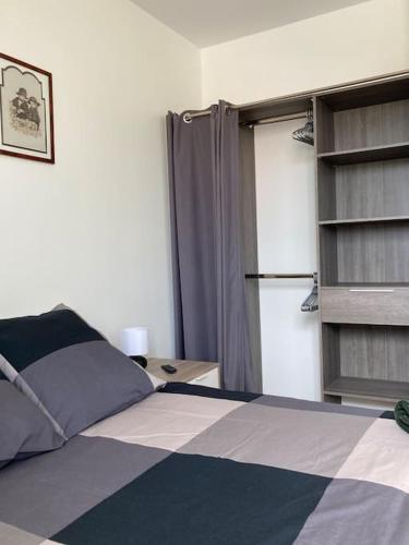 a bedroom with a bed and a window with a curtain at Appartement Broceliande in Saint-Malon-sur-Mel