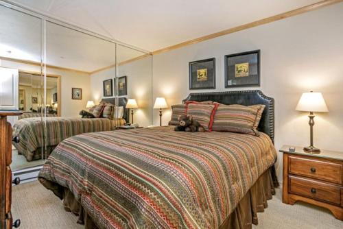 a bedroom with a large bed with a teddy bear laying on it at Vail Antlers 2 Bedroom Condo in Vail