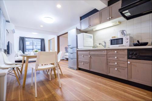 a kitchen and dining room with a table and chairs at Charming Guesthouse in the Heart of Okubo 丶Steps to Metro and Convenient Travel! EoW4 in Tokyo