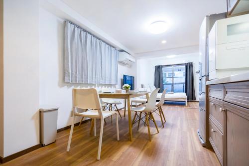 a kitchen and dining room with a table and chairs at Charming Guesthouse in the Heart of Okubo 丶Steps to Metro and Convenient Travel! EoW4 in Tokyo