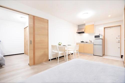 a kitchen and dining room with a table and chairs at CG Charming Guesthouse in the Heart of Okubo 丶Steps to Metro and Convenient Travel! YoE4 in Tokyo