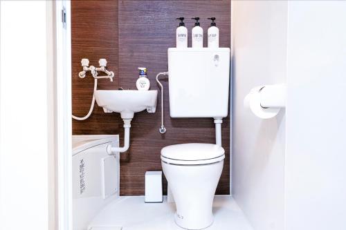 a bathroom with a toilet and a sink at CG Charming Guesthouse in the Heart of Okubo 丶Steps to Metro and Convenient Travel! YoE4 in Tokyo