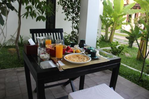 a black table with food and drinks on it at Villa Jaya in Siem Reap