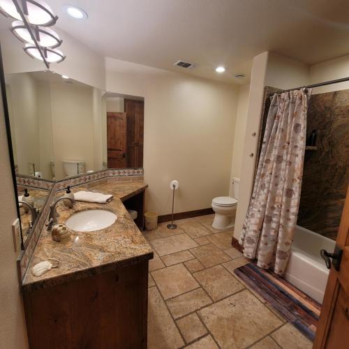 a bathroom with a sink and a shower at Kings River Reflections in Sanger