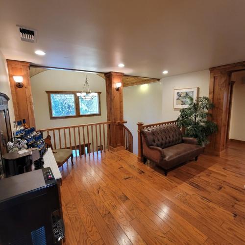 a living room with a couch and wooden floors at Kings River Reflections in Sanger