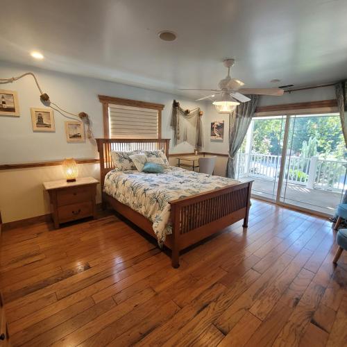 a bedroom with a bed and a wooden floor at Kings River Reflections in Sanger