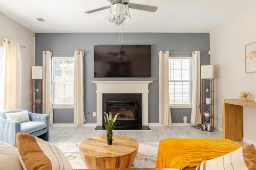 a living room with a couch and a fireplace at P&Ds Harmony House 20 Mins to Airport & Downtown in Decatur