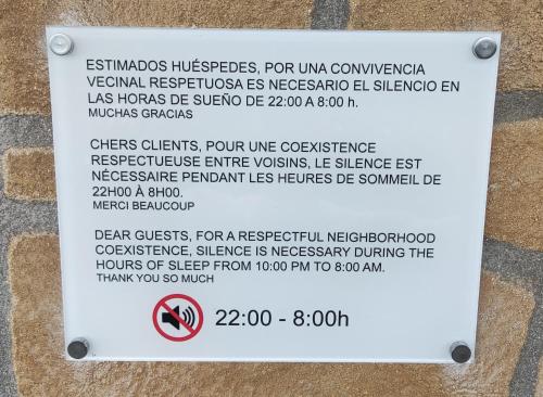 a sign on the side of a building with a sign that readsresidents interests at IGELDO HOUSE in Donostia-San Sebastián