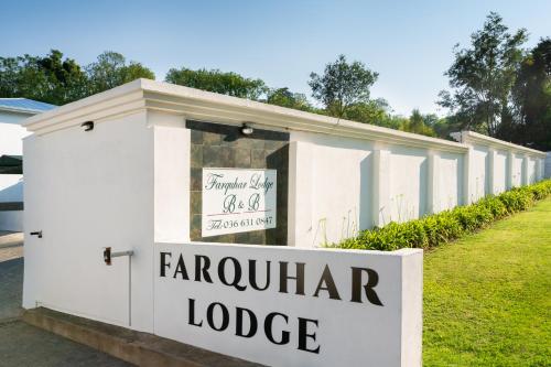 a sign for the entrance to a carouyard lodge at Farquhar Lodge in Ladysmith