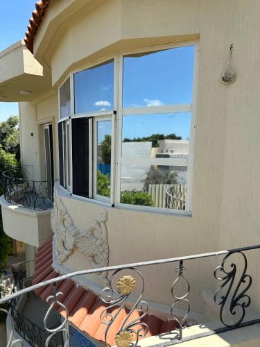 a balcony of a house with a window at Relaxing Villa with private pool in King Mariout