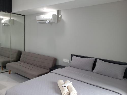 Ένα ή περισσότερα κρεβάτια σε δωμάτιο στο SleepRest @ Nagoya Mansion