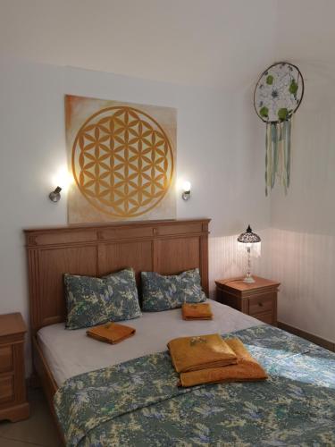 a bedroom with a bed with two towels on it at VILLA METATRON U DOMA in Balchik