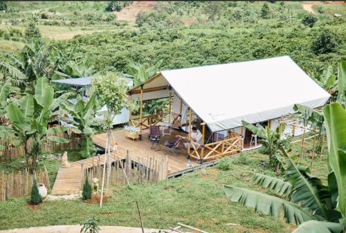 an aerial view of a house with a white tent at Adachi Farmstay Bảo Lộc in Bao Loc