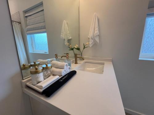 a white bathroom with a sink and a mirror at Minutes to Rock City, Ruby Falls, & Downtown in Chattanooga
