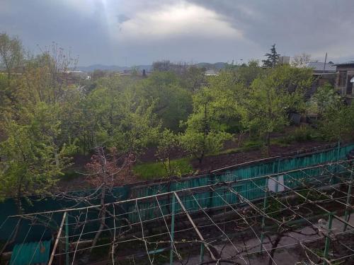 an overhead view of a fence with trees and a field at Дом где есть всё удобства 2 in Khashuri