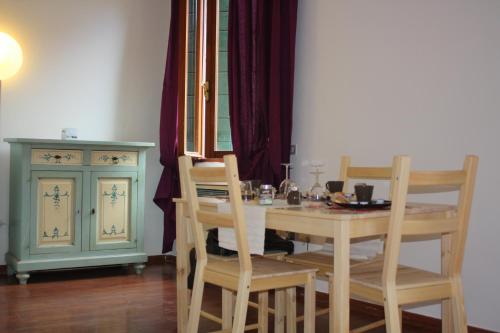 a dining room with a table and chairs and a cabinet at San Severo in Venice