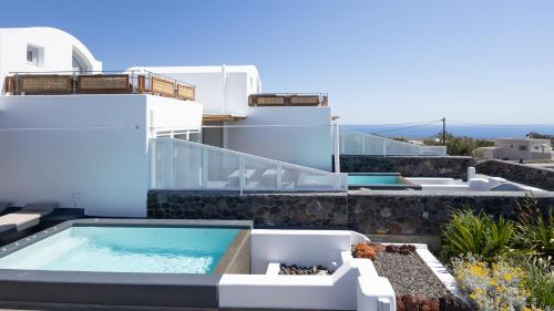 a swimming pool on the side of a house at Soil of Sun Luxury Villas in Megalokhori
