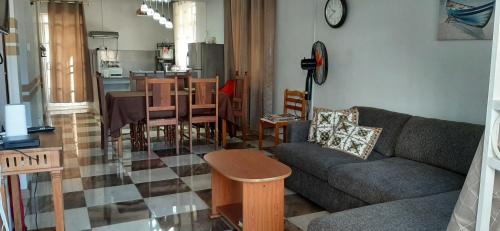 a living room with a couch and a table at Ground Floor Lovely two bedrooms apartment in Flic-en-Flac