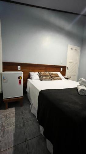 a bedroom with a large bed in a room at Casa da Vila - Hospedaria - 3 min do centrinho de Alter in Alter do Chao