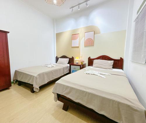 Katil atau katil-katil dalam bilik di Quoc Dinh Guest House