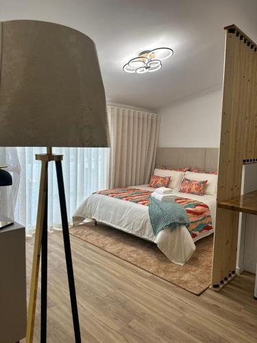 a bedroom with a bed and a lamp at At Maries Beach House Peniche 2 in Peniche