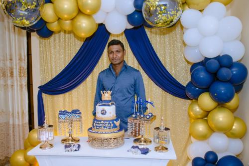 a man standing in front of a table with a cake at Heaven Palace in Kandy