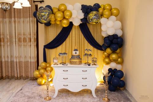 a birthday party with a cake and balloons at Heaven Palace in Kandy