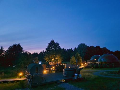 a group of domes and tents at night at Namiot glampingowy Loft in Krzesimów