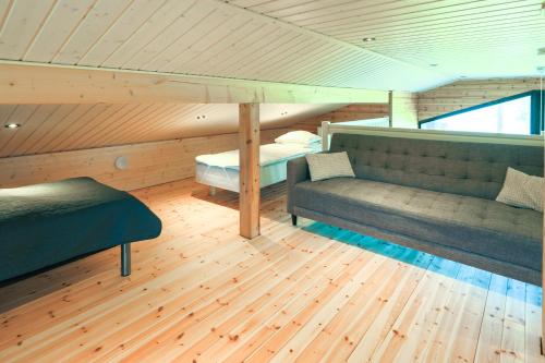 a room with two couches and a bed in a house at Villa Rantaniitty in Tampere