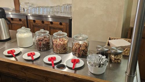 a counter with jars of granola and red ribbons at Hotel Opat in Kutná Hora