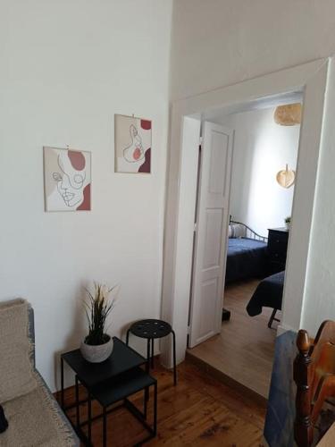 a living room with a couch and a bedroom at To stegadaki - Traditional Cycladic Mansion in Ano Syros