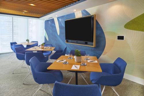 a conference room with tables and chairs and a flat screen tv at Renaissance Honolulu Hotel & Spa in Honolulu