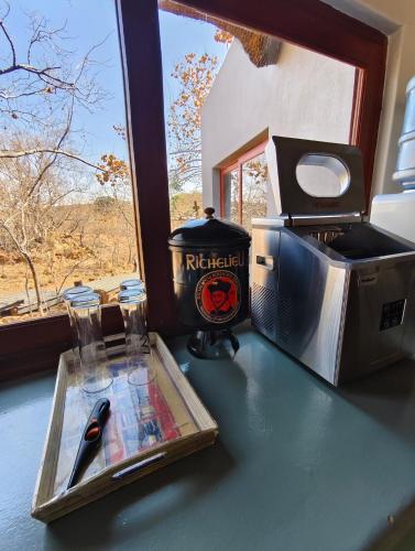 a table with a knife and a toaster and a pair of scissors at Milkwood Safari Lodge in Warmbaths
