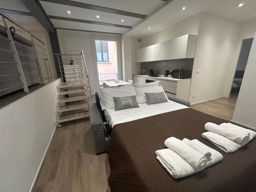 a bedroom with a large bed with towels on it at Ariosti 3 - Piazza Maggiore in Bologna