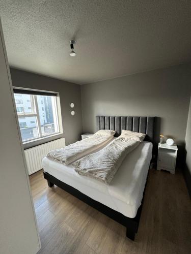 a bedroom with a bed and a window at Comfy flat in Kópavogur in Reykjavík