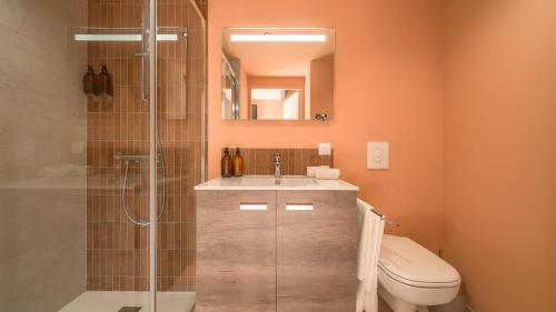 a bathroom with a toilet and a sink and a shower at Domaine Carrel & Senger in Jongieux