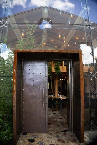 an open door into a patio with a table at Kazerma e Cerenit in Surrel