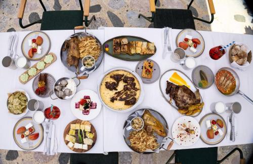 a white table topped with lots of plates of food at Kazerma e Cerenit in Surrel