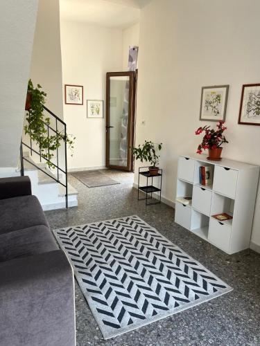 a living room with a couch and a rug at Casa Vacanze Tra gli Olivi in Bonarcado