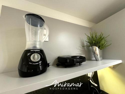 a blender sitting on a shelf in a kitchen at Move - Tambaú in Tambaú