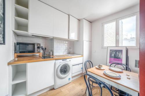 une cuisine équipée d'un lave-linge et d'un lave-linge/sèche-linge. dans l'établissement Appartement confortable dans le centre de Paris, à Paris