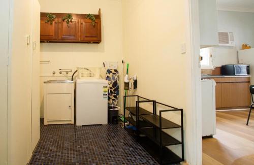 a kitchen with a washer and dryer in a room at Rustic Hills Getaway in Bickley