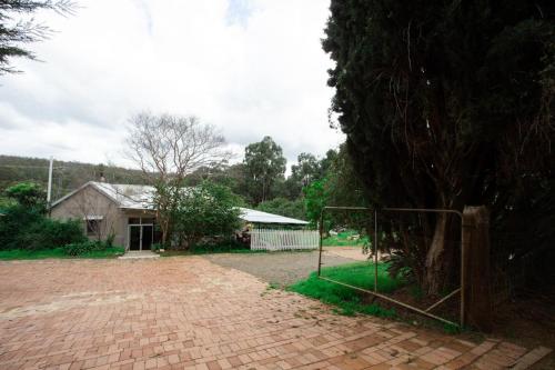 a brick driveway with a gate in front of a house at Rustic Hills Getaway in Bickley